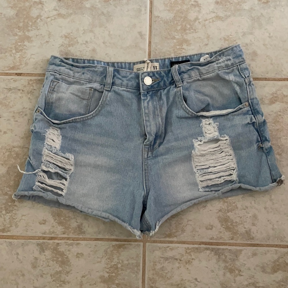 Light wash, distressed high-rise jean shorts.